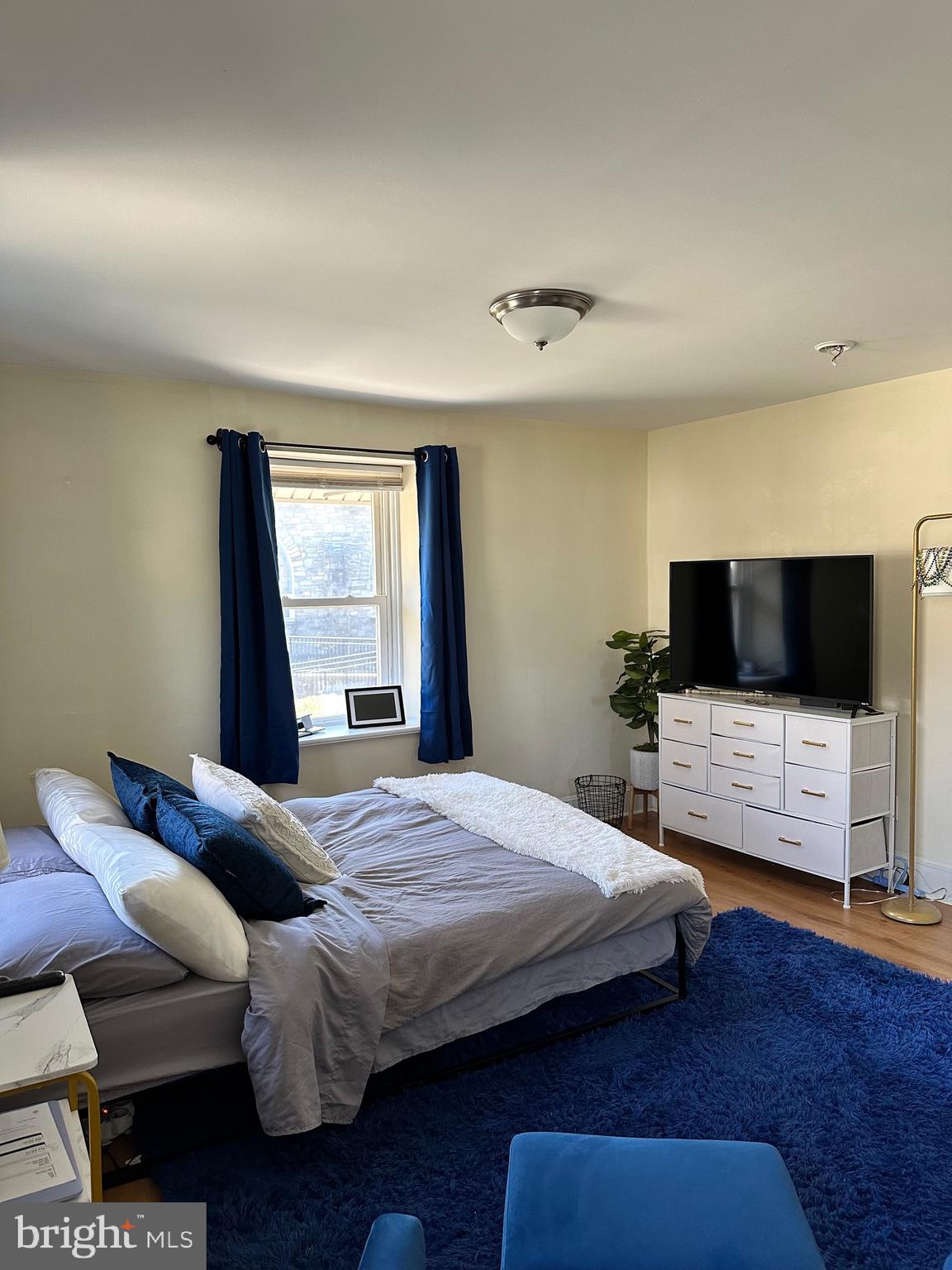 244 Highland Avenue, Unit 6 Wayne, PA 19087 - Photo 18 of 25 a bedroom with a bed and a television