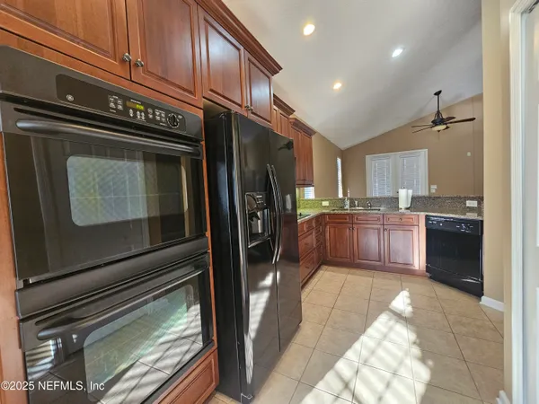 a kitchen with stainless steel appliances granite countertop a refrigerator and a sink