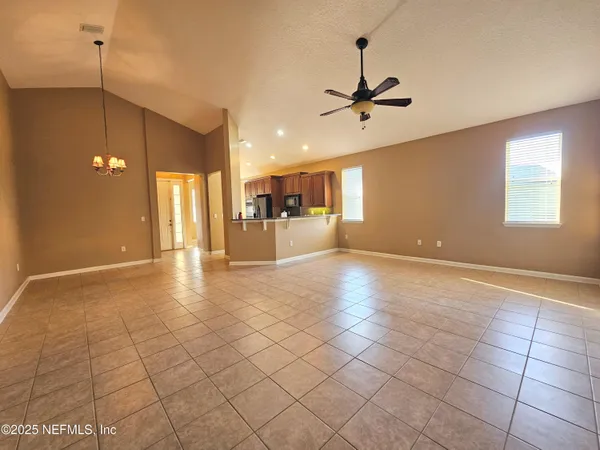 a view of a kitchen with a sink and a chandelier fan