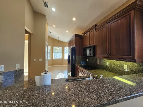 a view of a kitchen with a sink and a stove
