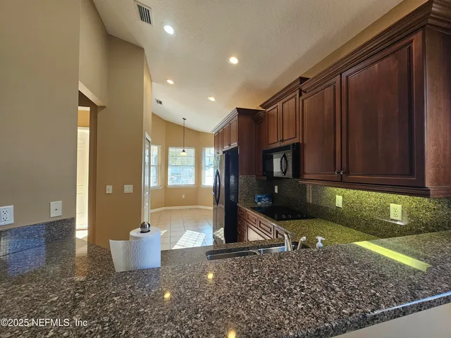 a view of a kitchen with a sink and a stove
