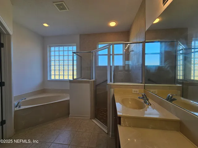 a bathroom with a tub and a sink
