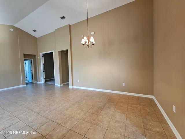 a view of a chandelier in big room and chandelier