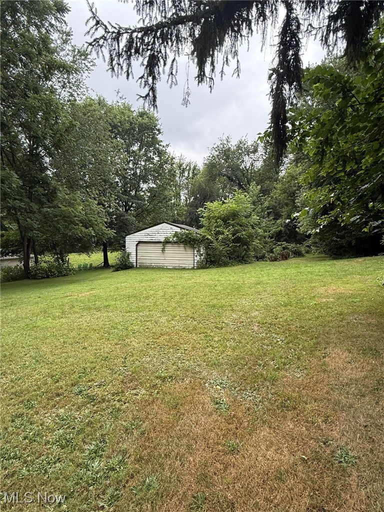2188 Stahl Road Akron, OH 44319 - Photo 4 of 5 View of grassy yard featuring a detached garage and an outbuilding