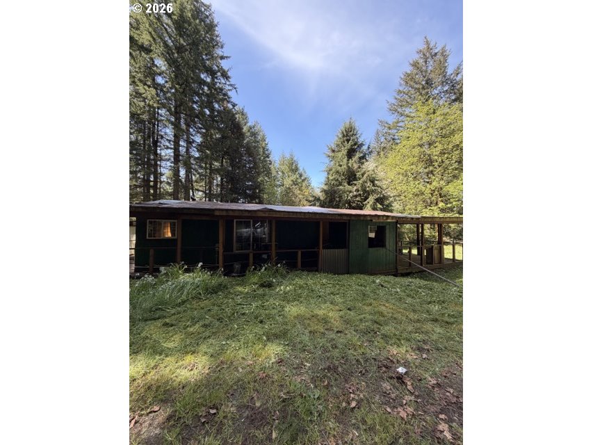 1499 Carlson Road Reedsport, OR 97467 - Photo 1 of 16 a backyard of a house with lots of green space