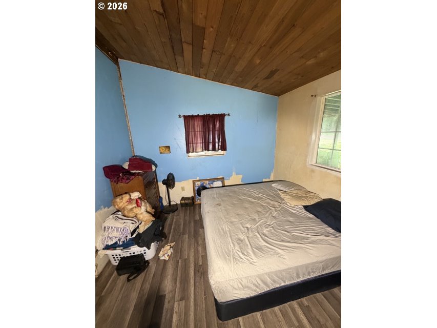 1499 Carlson Road Reedsport, OR 97467 - Photo 11 of 16 a bedroom with a bed and a painting on the wall