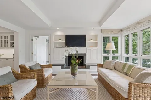 a living room with furniture flat screen tv and a fireplace