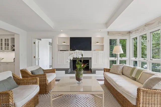 a living room with furniture flat screen tv and a fireplace