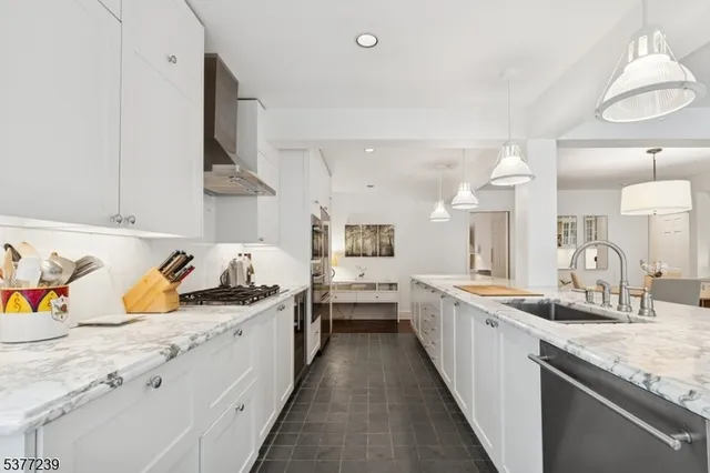 a kitchen with sink stove top oven and cabinets