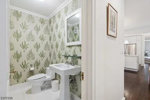a bathroom with a sink a toilet and shower curtain