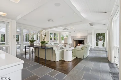 a living room with furniture a large window and a fireplace