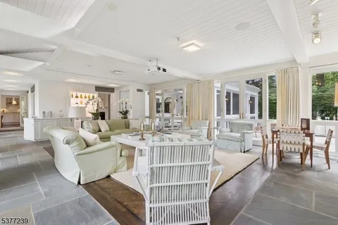 a dining room with furniture and a large window