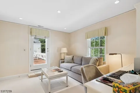 a spacious bedroom with a bed and a chandelier