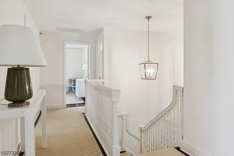 a view of a livingroom with furniture staircase and a ceiling fan