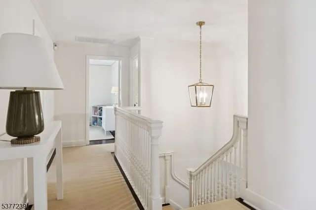 a view of a livingroom with furniture staircase and a ceiling fan