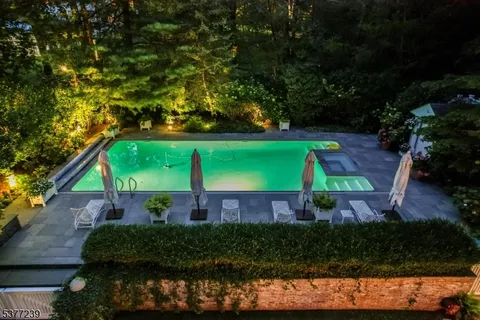 a view of house with swimming pool patio and outdoor seating