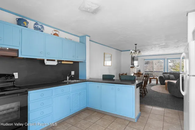 a kitchen with granite countertop a sink a stove and cabinets