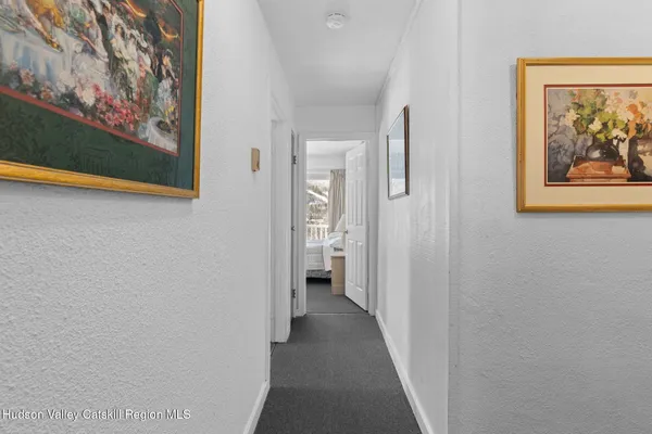 a view of a hallway with paintings on the wall