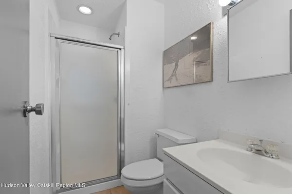 a white toilet sitting next to a bathroom sink