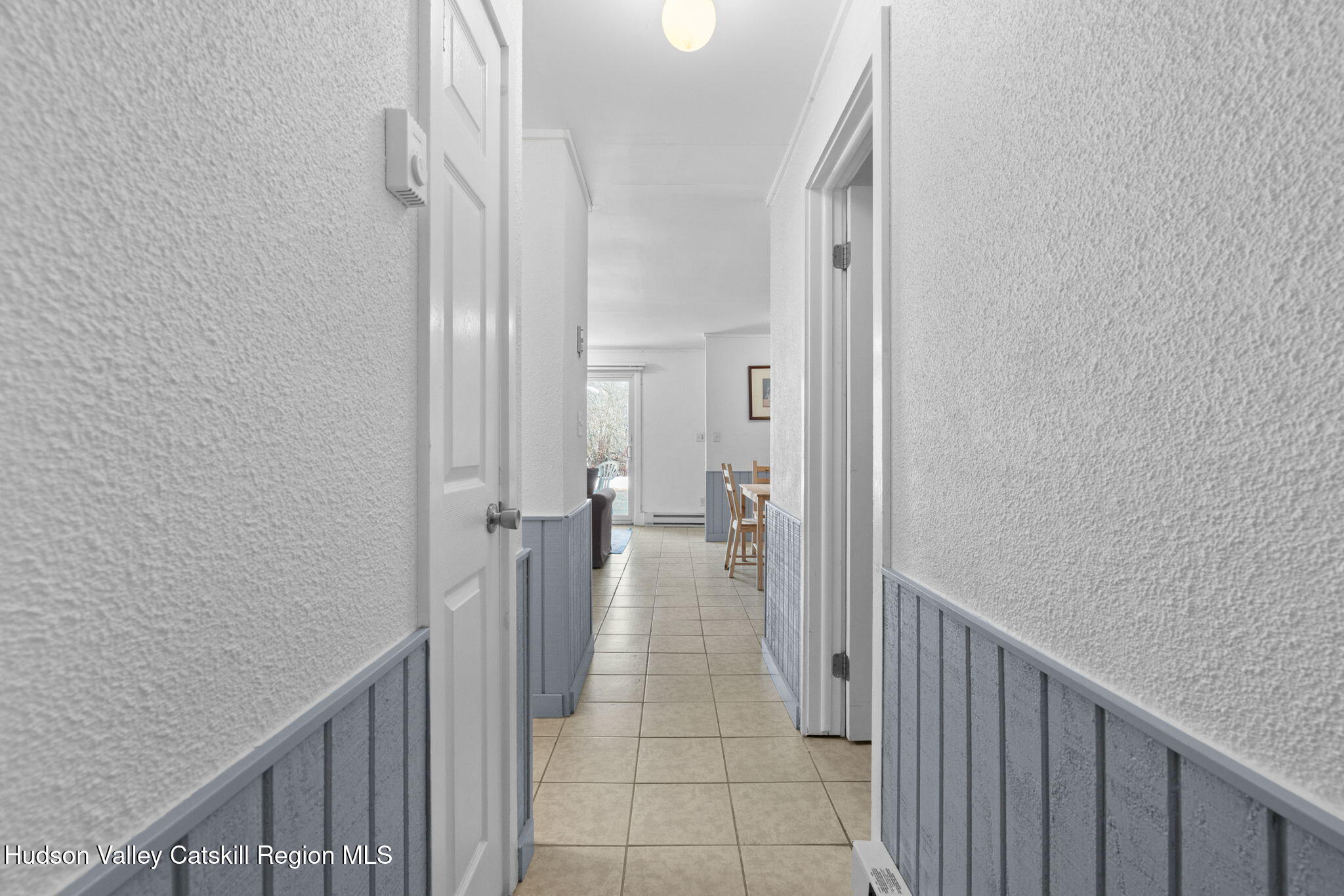 55 Scribner Hollow Road, Unit B4 Hunter, NY 12442 - Photo 31 of 39 a view of a hallway with a livingroom and dinning room with wooden floor