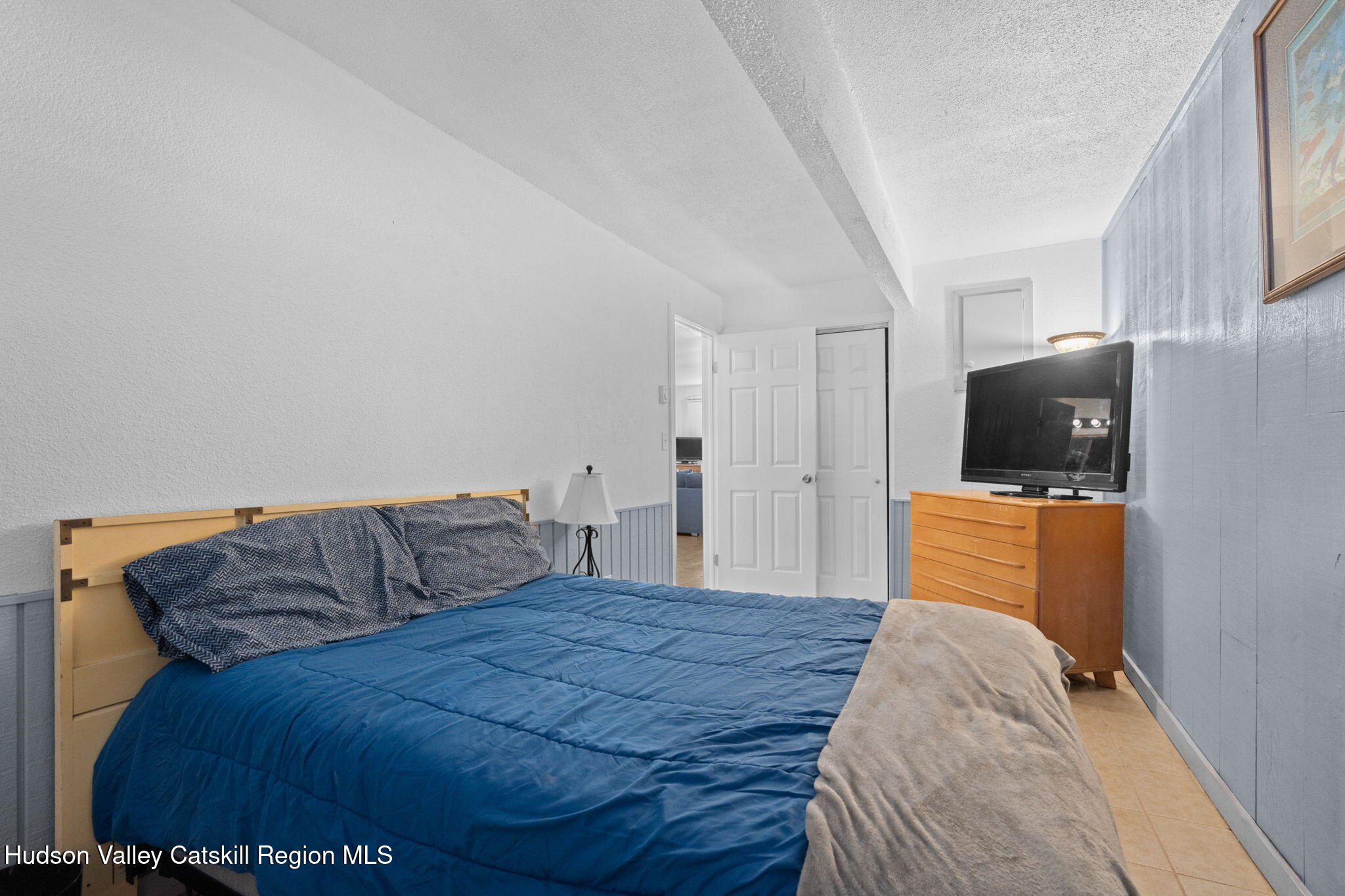 55 Scribner Hollow Road, Unit B4 Hunter, NY 12442 - Photo 32 of 39 a bedroom with a bed and couch