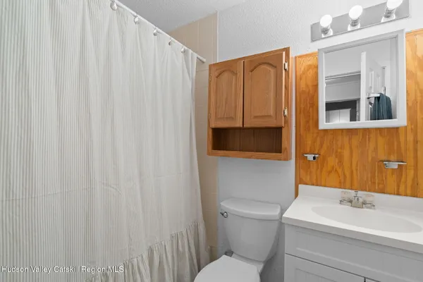 a bedroom with a bed and a lamp