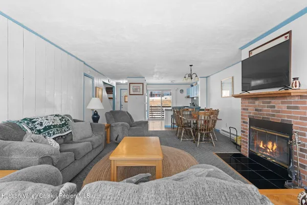 a living room with furniture a flat screen tv and a fireplace