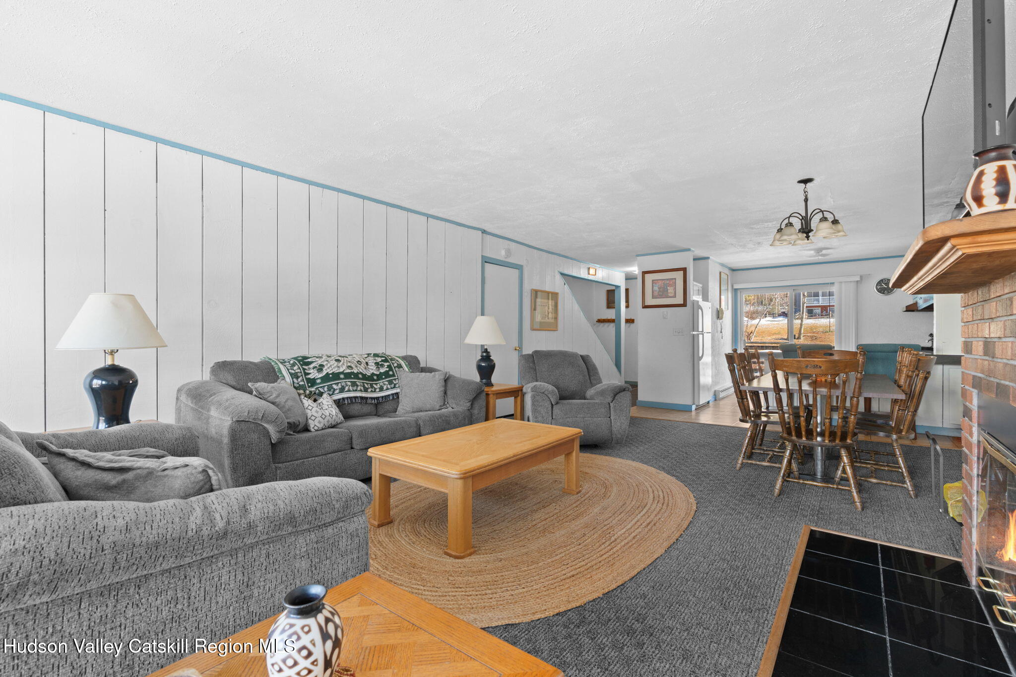 55 Scribner Hollow Road, Unit B4 Hunter, NY 12442 - Photo 6 of 39 a living room with furniture a rug and a window