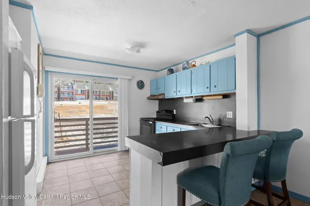 a kitchen with a table chairs and a refrigerator