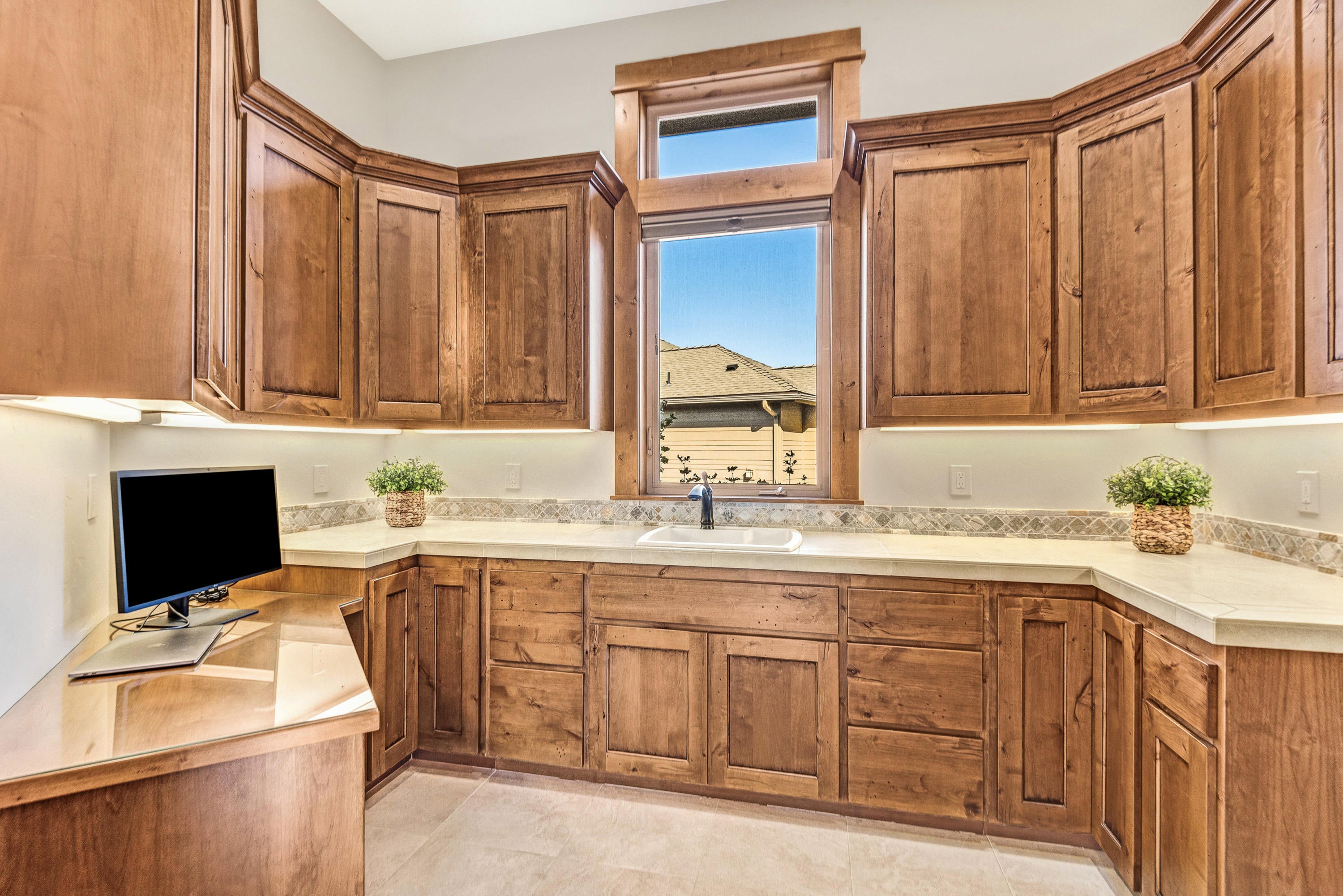 1133 Highland View Loop Redmond, OR 97756 - Photo 31 of 59 Separate huge laundry room with extensive cabinets and built-in desk