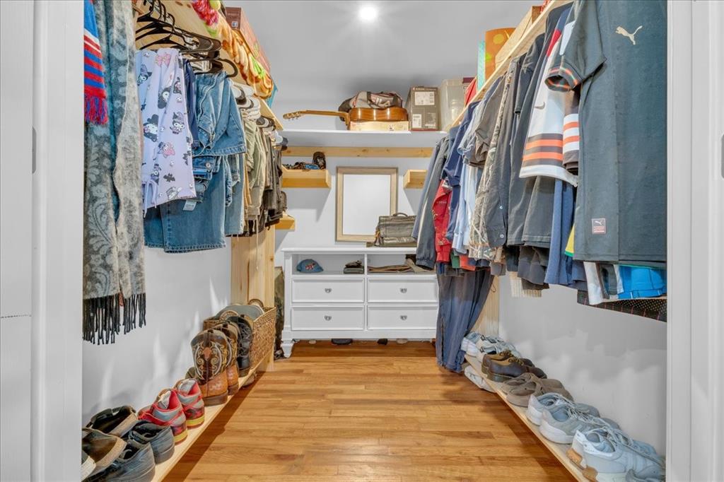 4120 Benjamin Road Caney City, TX 75148 - Photo 32 of 36 Custom closet system featuring wood-finish flooring, white walls, and recessed lighting