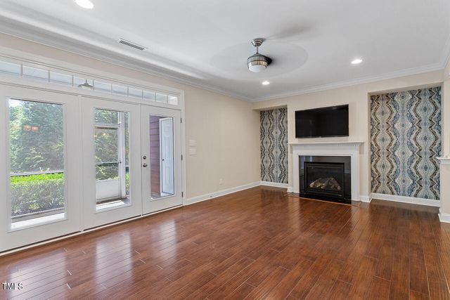 a view of an empty room with a fireplace and a window