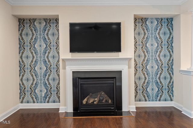 a living room with a fireplace and a flat screen tv