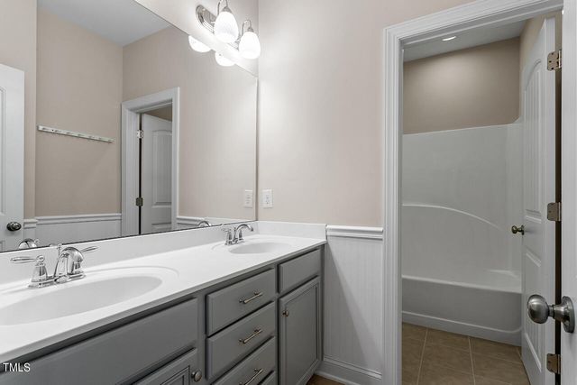 a bathroom with a sink a vanity and a mirror