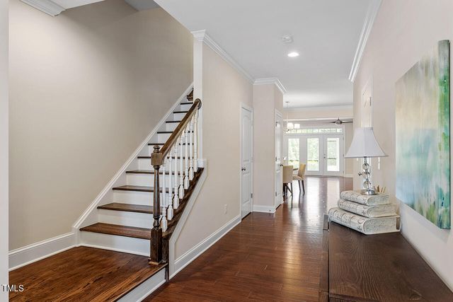 a view of front door with wooden floor and stairs
