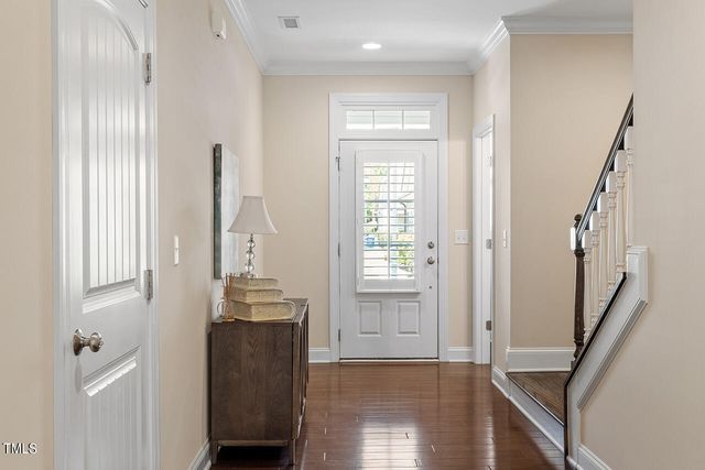 a view of a hallway with wooden floor and stairs