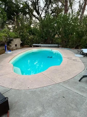 a view of a swimming pool with a yard