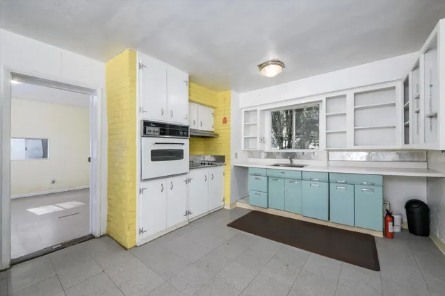 a kitchen with a sink and cabinets