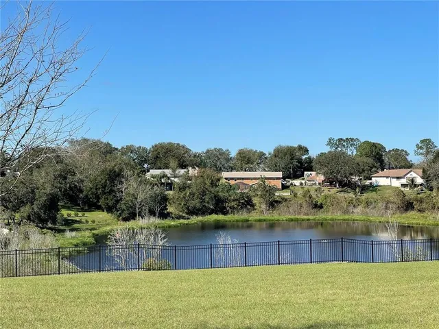 a view of a lake with a house in the background