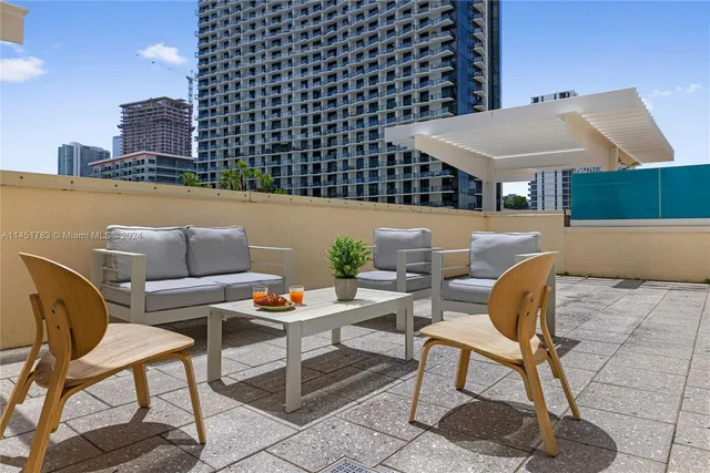 a roof deck with a table and chairs