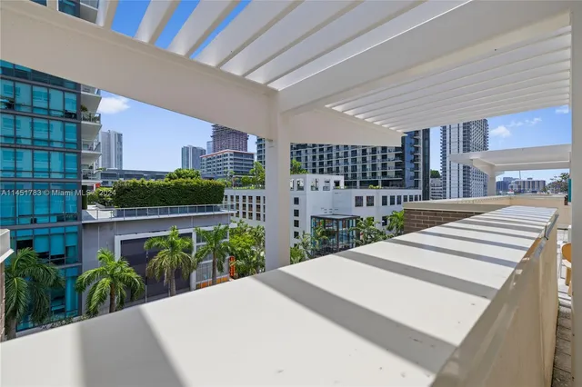 a view of a building with a garden from a balcony