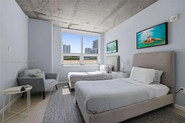 a bedroom with two beds and a window