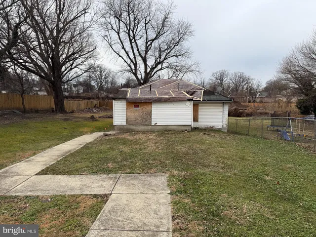 a front view of house with yard and trees