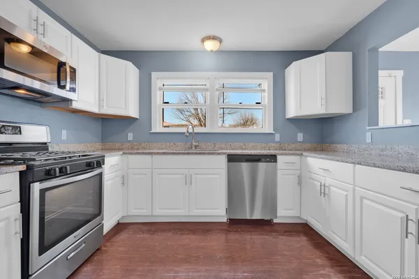 a kitchen with stainless steel appliances granite countertop a stove and a sink