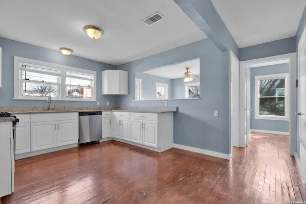 a kitchen with granite countertop a stove and a sink