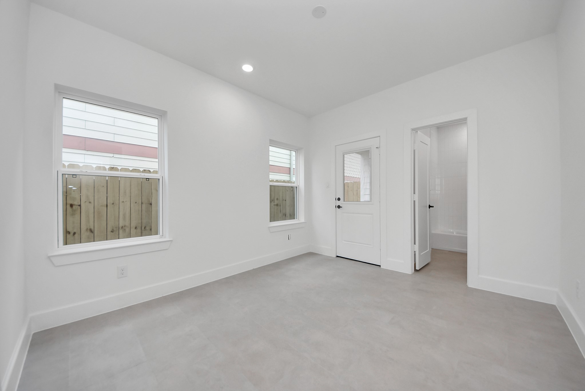 923 Fisher Street, Unit A Houston, TX 77018 - Photo 32 of 47 This versatile room offers light-filled space with two large windows and direct access to a private outdoor area. The neutral tones and clean finishes provide flexibility, whether as a bedroom, office, or hobby space.