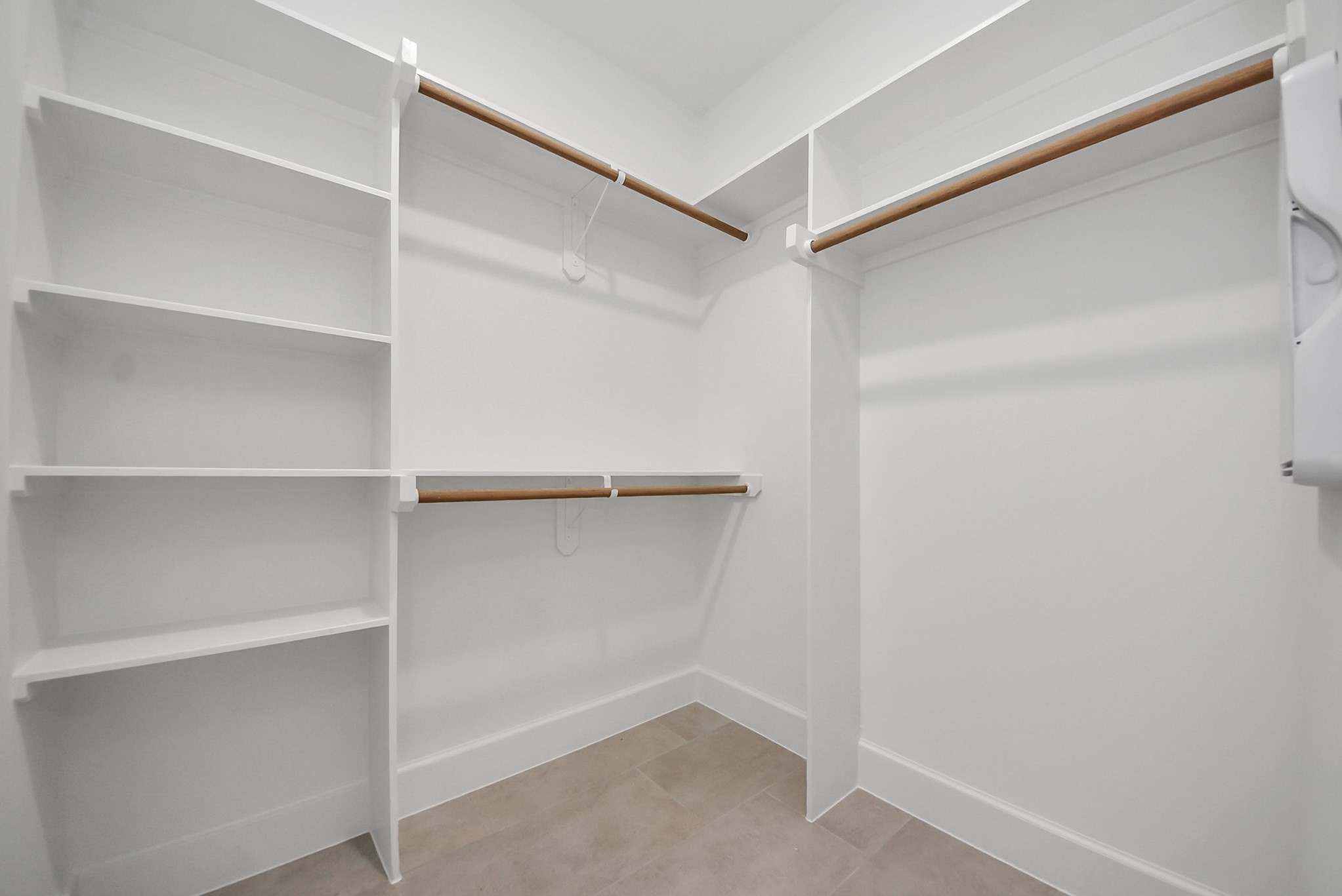923 Fisher Street, Unit A Houston, TX 77018 - Photo 33 of 47 Experience this spacious walk-in closet with thoughtfully designed shelves and hanging rods. Its clean lines and neutral tones make organization effortless while maintaining a modern aesthetic.