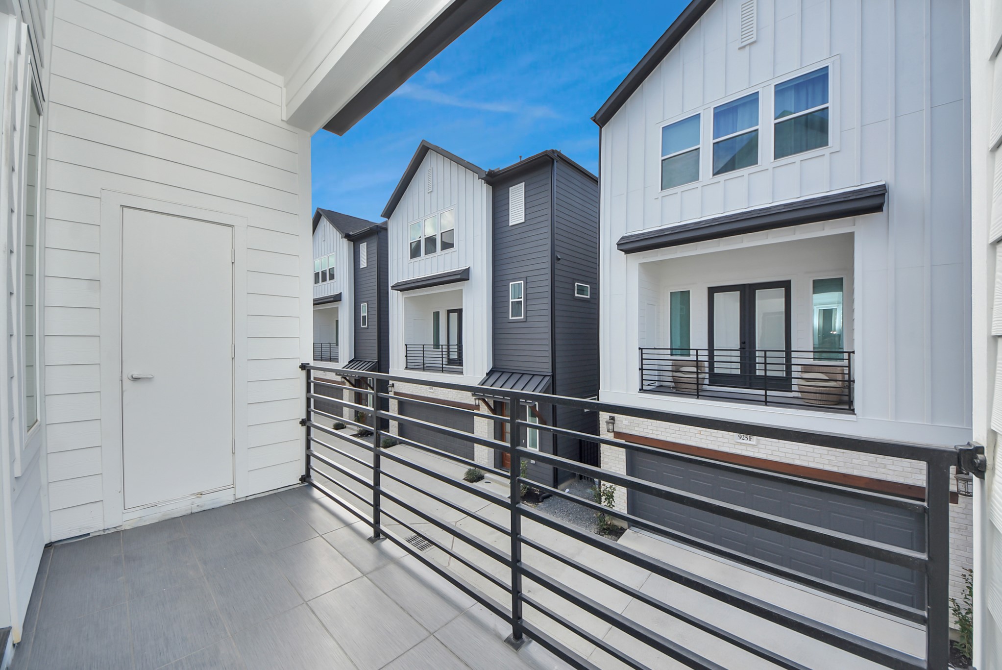 923 Fisher Street, Unit A Houston, TX 77018 - Photo 38 of 47 Step outside to enjoy this balcony view overlooking a row of contemporary townhouses. The space invites you to relax outdoors while enjoying the vibrant, well-kept neighborhood below.