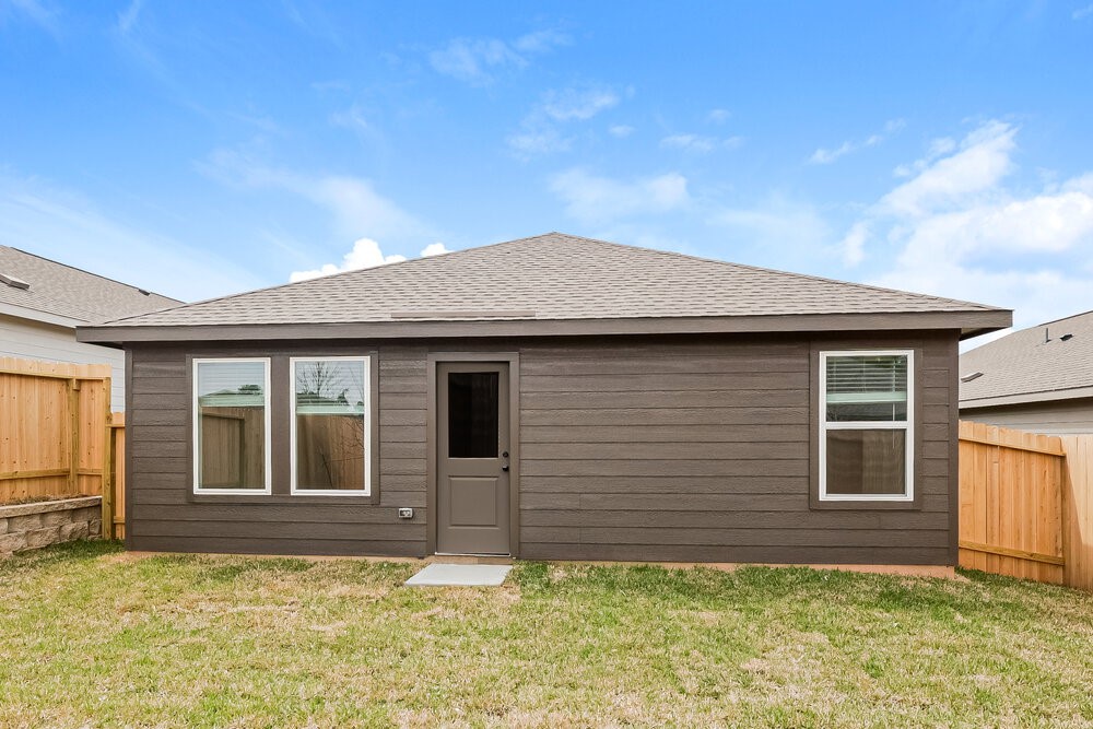 621 Craven Street Conroe, TX 77316 - Photo 15 of 16 a house that has a large window in front of it