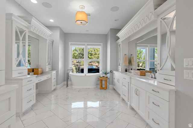 2917 Old Farm Road Washington, UT 84780 - Photo 40 of 105 Bathroom with vanity, a soaking tub, recessed lighting, and light marble finish flooring